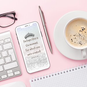 May include: A smartphone displaying a motivational quote with a silver glitter background and a crown graphic. The quote reads "Perhaps this is the moment for which you were created!" with the scripture reference "Esther 4:14".