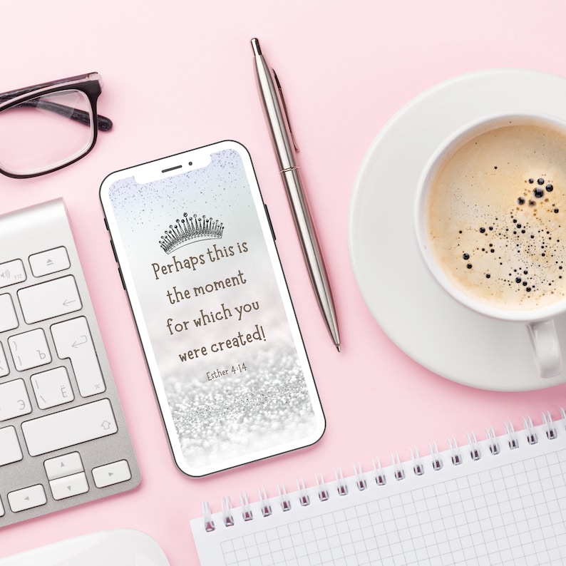 May include: A smartphone displaying a motivational quote with a silver glitter background and a crown graphic. The quote reads "Perhaps this is the moment for which you were created!" with the scripture reference "Esther 4:14".