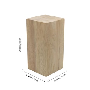 May include: A natural wood block, measuring 8 inches tall and 4 inches wide. The block is made of light brown wood with a smooth surface.