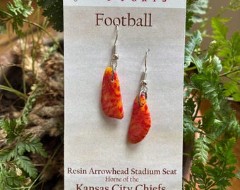 Repurposed Kansas City Chiefs Arrowhead stadium seat shredded and suspended in epoxy resin. NFL seat ads history to this football gift