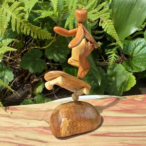 Skateboarder Mini Sculpture on wood base made from figured Vermont Hardwood and pieces of sports equiptment