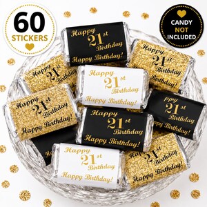 May include: A collection of rectangular candy bar stickers featuring black, white, and gold glitter designs. Each sticker displays the text Happy 21st Birthday in various fonts. The set includes 60 stickers, and the image notes that candy is not included.