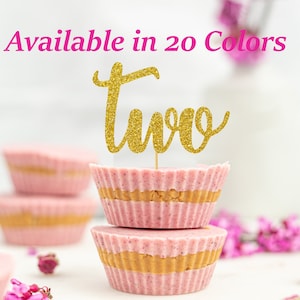 May include: Gold glitter "two" cake topper on a stack of pink and beige cupcakes. Available in 20 colors.