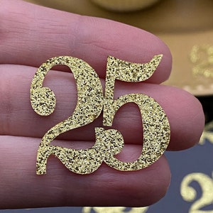 May include: Gold glitter number 25, a decorative topper for cakes or other crafts.