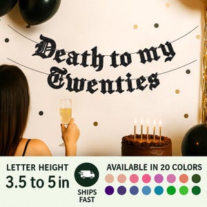 May include: A black glittery banner with the text Death to my Twenties hanging on a wall. The letters are between 3.5 to 5 inches in height. The banner is displayed above a chocolate cake with five lit candles and black balloons.