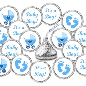 May include: A set of 12 round baby shower favor stickers with blue and white designs. The stickers feature a baby carriage, baby footprints, and the text "It's a Boy!" and "Baby Boy!"