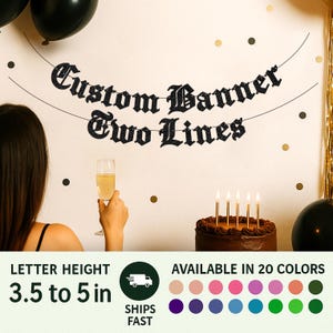 May include: A black glittery custom banner with two lines of text reading Custom Banner Two Lines, suspended on a string. The banner features a gothic-style font. Text on the image indicates a letter height of 3.5 to 5 inches for the product.