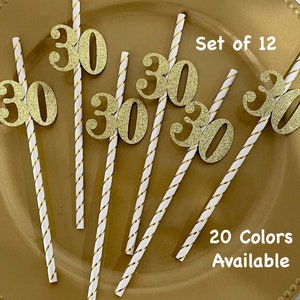 May include: Set of 12 gold glitter straws with the number 30 on each straw. The straws are white with gold stripes. The text "Set of 12" and "20 Colours Available" is printed on the background.
