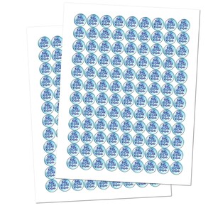 May include: Two sheets of sticker paper with 100 round stickers. Each sticker has a blue watercolor background with the text "Baby it's cold outside" in purple.