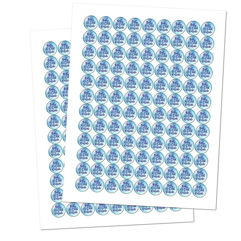 May include: Two sheets of sticker paper with 100 round stickers. Each sticker has a blue watercolor background with the text "Baby it's cold outside" in purple.
