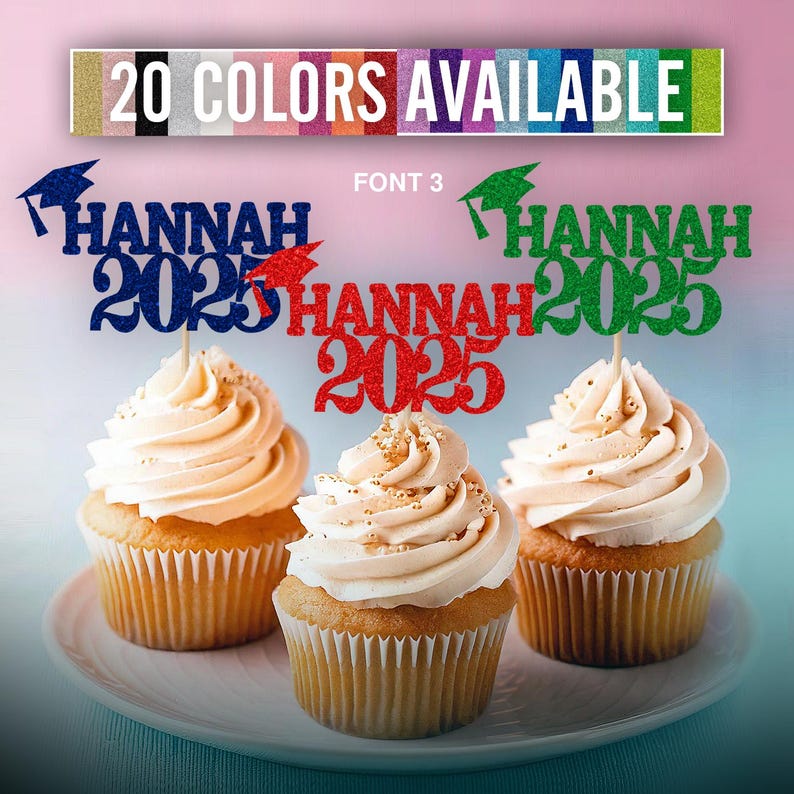May include: Three cupcakes decorated with graduation themed toppers. The toppers are made of glitter cardstock and feature the name "HANNAH" and the year "2025". The toppers are in blue, red, and green.