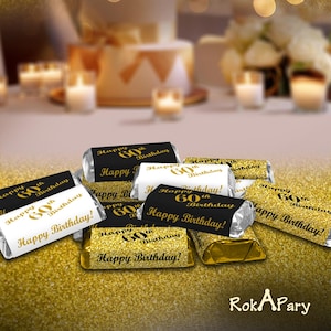 May include: Gold and black favor boxes with gold glitter and the text "Happy 60th Birthday!" printed on them.