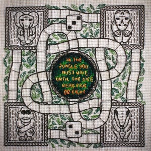 May include: A black and white embroidered design of a game board with a jungle theme. The board features a winding path, dice, and animals. The text "In the jungle you must wait, until the dice reach five or eight" is in the center of the board.