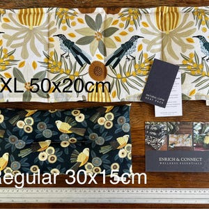 May include: Two rectangular heat packs, one XL (20x50cm) and one regular (15x30cm), with floral and bird patterns. The XL pack features birds and yellow flowers on a white background. The regular pack has birds and floral designs on a dark blue background.
