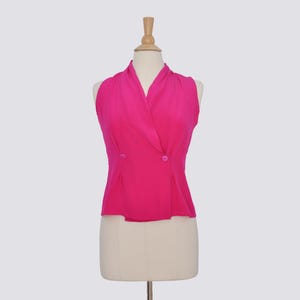 May include: A sleeveless, hot pink, double-breasted blouse with a V-neckline and a fitted silhouette.