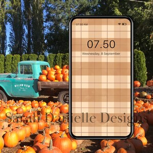 May include: A teal blue pickup truck with the words "Willow View Est 1988" on the side is parked in a field of orange pumpkins. A smartphone with a brown and white plaid background shows the time 07:50 and the date Wednesday, 8 September.
