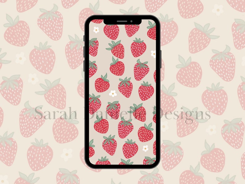 May include: A smartphone displaying a digital wallpaper with a pattern of red strawberries and white flowers on a light beige background.