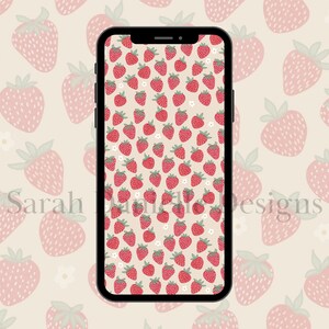 May include: A digital phone screen displaying a pattern of pink and red strawberries on a cream background. The text "Sarah Ann Designs" is visible at the bottom of the screen.