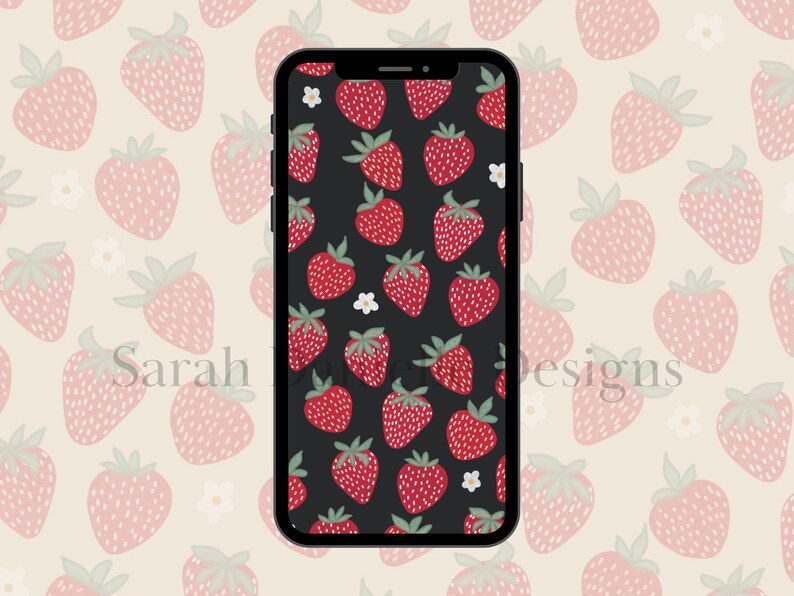 May include: A black phone screen with a pattern of red strawberries and white flowers on a black background. The phone is surrounded by a pattern of pink strawberries on a cream background.