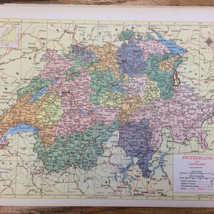 May include: A vintage map of Switzerland with colored borders showing the cantons. The map includes a compass, scale of miles, and key showing capitals of cantons, international boundaries, and railroads. The text "SWITZERLAND and LIECHTENSTEIN" is printed in the bottom right corner.