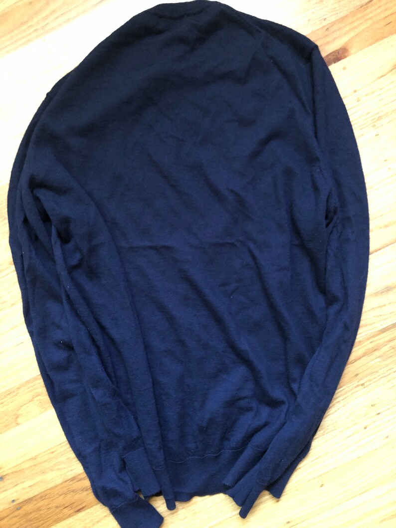 K&ouml;nnte beinhalten: Ein dunkelblauer Langarm-Pullover aus weichem Strickstoff.
