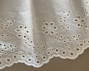 May include: White cotton lace trim with a scalloped edge and delicate floral embroidery.