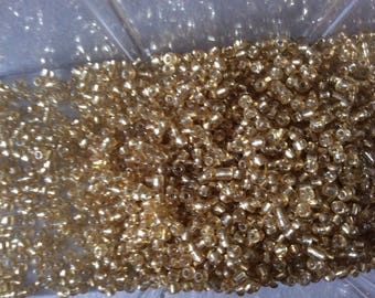 Golden colored seed beads 2.5 mm Approximately