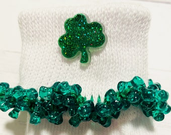 May include: White socks with a green shamrock on the top and a green shamrock trim around the cuff.