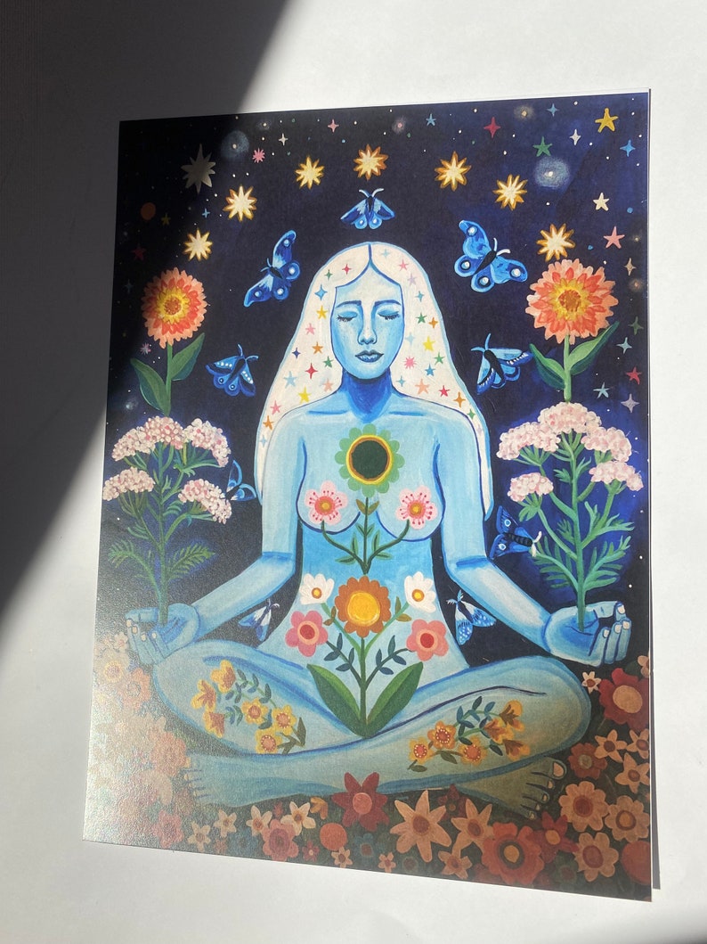 May include: A blue figure sits in a meditative pose surrounded by flowers and stars. The figure has a flower growing from their chest and is surrounded by butterflies and stars.