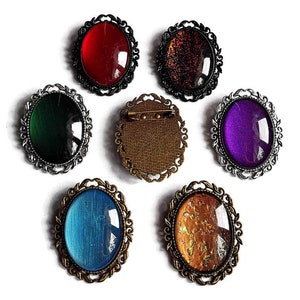 Oval brooch in your desired color made of glass stones in black, silver and bronze as cosplay jewelry and gothic accessory
