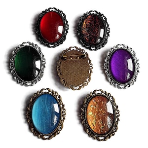 Oval brooch desired color made of glass stones in black silver and bronze as a cosplay brooch and gothic jewelry accessory