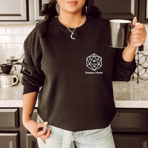 May include: Black sweatshirt with a white graphic of a twenty-sided die and the text "Dungeon Master".