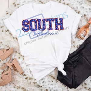 May include: White t-shirt with a blue and red glitter design that says "SOUTH Alabama".