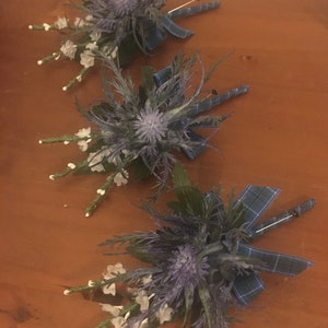 6 x Blue Scottish thistle and white heather button holes with Douglas tartan ribbon (please note dispatch time is 4 weeks from purchase)