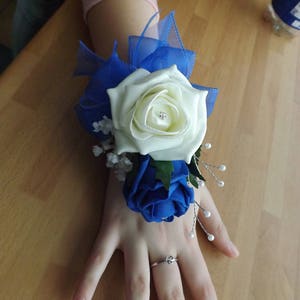 Ivory and royal blue foam rose wrist corsage with diamante and sprays of pearls
