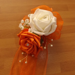 Ivory and orange foam rose wrist corsage with diamante and sprays of pearls (please note dispatch time is 4 weeks from purchase)