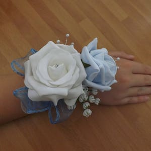 White and baby blue foam rose wrist corsage with diamante and sprays of pearls (please note dispatch time 4 weeks from purchase)