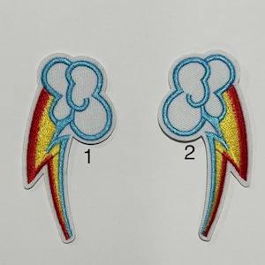 May include: Two embroidered patches featuring a cloud with a blue outline and a rainbow-colored lightning bolt. The patches are numbered 1 and 2. The patches are on a white background.