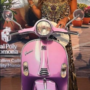 May include: A pink Vespa scooter with a round headlight and chrome mirrors. The scooter has a license plate that says "California". The scooter is parked on a wooden surface.
