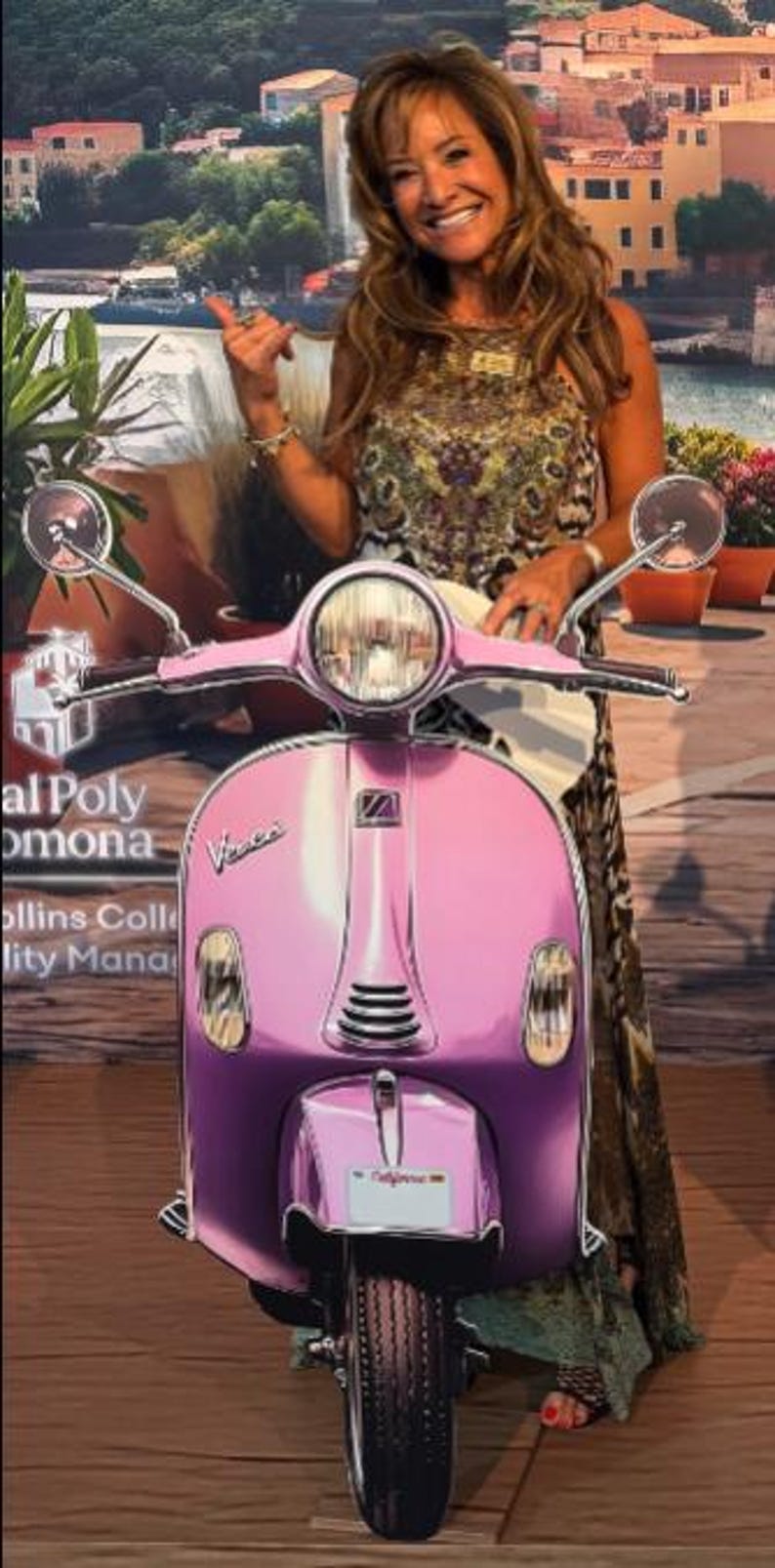 May include: A pink Vespa scooter with a round headlight and chrome mirrors. The scooter has a license plate that says "California". The scooter is parked on a wooden surface.