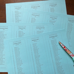 May include: A set of 10 blue cards with white text. Each card has a month of the year and a theme related to drawing near to God. The themes include "Glory of God", "Blessings from God", "31 Days of Light", "Armor of God", "Promises of God", "Power of God", "Walking with God", "Abiding in Him", "Growing in Him", and "Names of God". Each card lists bible verses related to the theme.