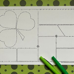 May include: A printable sheet with a shamrock design and several blank boxes with different borders. The sheet is perfect for practicing different types of stitching.