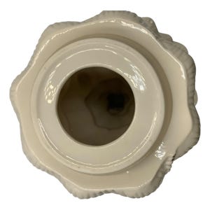 May include: White ceramic lidded jar with a textured, tree-like design. The lid is open, revealing the inside of the jar.
