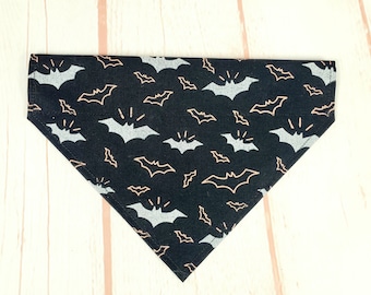 May include: Black bandana with a silver and copper bat pattern.