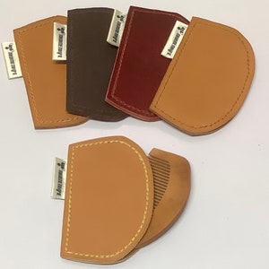 May include: Five leather pouches in brown, red, and tan with a small label that reads "The Leather Craft" on each. One pouch is open to reveal a wooden comb.