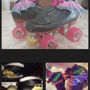 May include: A pair of black roller skates with pink wheels and pink bat wings attached to the sides. The skates have white laces and the words "Hand Made in U.S.A." are printed on the side of the skates.