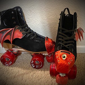 May include: A pair of black roller skates with red dragon-themed toe stops and wings. The skates have black wheels with red hubs and the words "PULSE" printed on the wheels.
