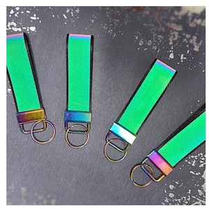Reflective keyring, smaller size, safety hi visibility, belt loop, key loop, reflective glow, green colour with rainbow hints.
