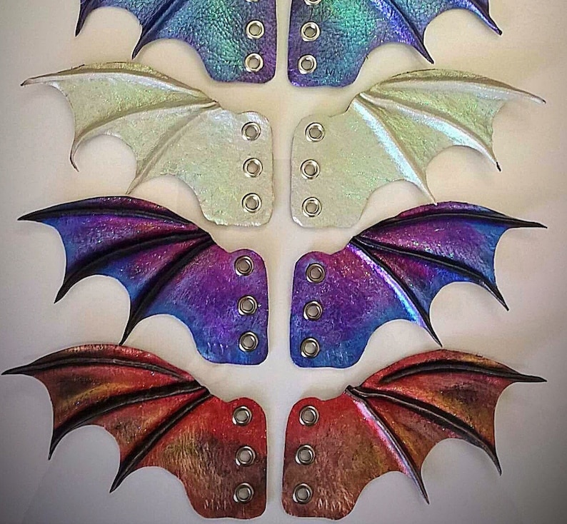 May include: Four pairs of leather dragon wing shoe laces in different colors: iridescent blue, white, purple, and red. Each pair has five eyelets for lacing.