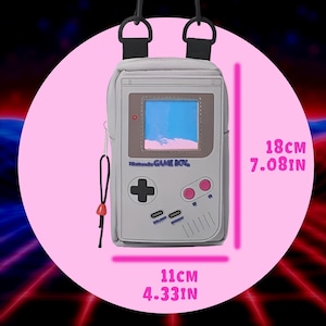 May include: A light gray shoulder bag designed to resemble a Nintendo Game Boy. The bag features a screen, buttons, and the words "Nintendo GAME BOY". It measures 11 cm (4.33 in) wide and 18 cm (7.08 in) tall.